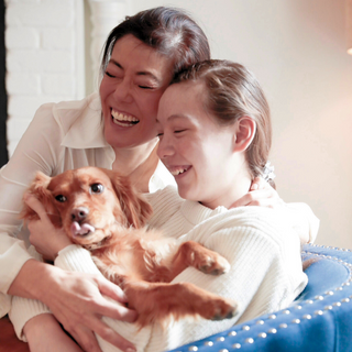 Angela, daughter, and dog zoe, cuddling