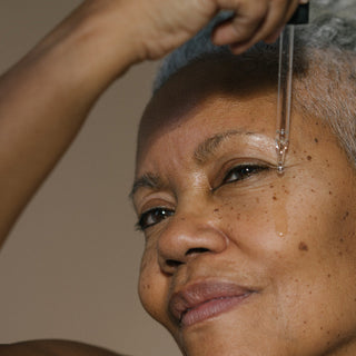 Woman applying cleansing oil to face